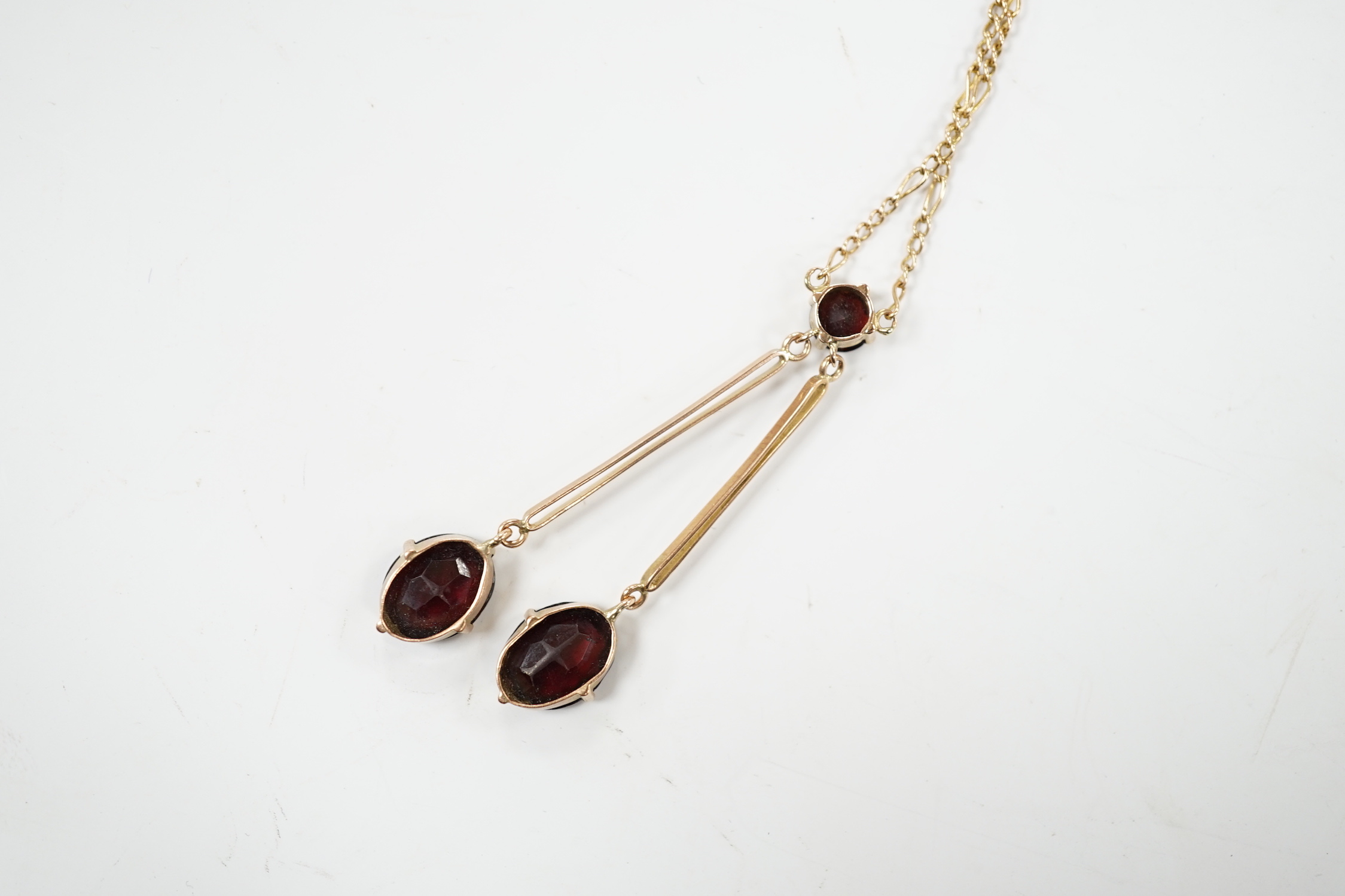 A 9k and three stone garnet set double drop pendant necklace, overall 52cm, gross weight 5.3 grams.